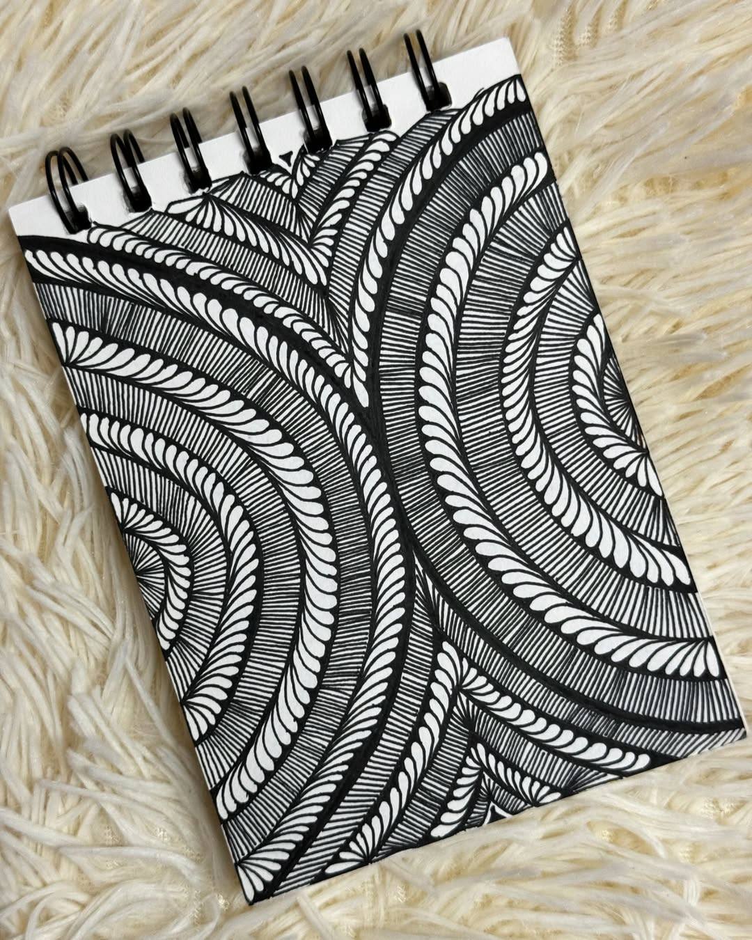 🖤🌀 Flowing lines, hypnotic calm 🌀🖤

This mesmerizing piece by @tashvisart pulls you in with its rhythmic curves and perfectly repeated strokes. The bold black ink paired with clean negative space creates a soothing visual flow that feels both energetic and meditative at the same time. ✨

Why this artwork stands out:

1️⃣ Graceful line flow — the curves guide your eyes smoothly across the page
2️⃣ Strong black-and-white contrast — bold yet calming
3️⃣ Consistent pattern rhythm — repetition that feels grounding, not busy
4️⃣ Beautiful spacing — detailed without feeling crowded
5️⃣ Mindful movement — the kind of art you can stare at and slowly unwind

Art by: @tashvisart 💛

#DoodleArt #InkArt #PatternDrawing #MindfulDrawing #BlackAndWhiteArt #SketchbookArt #CreativeCalm #ZentangleInspired #ArtForRelaxation #CreativeFlow