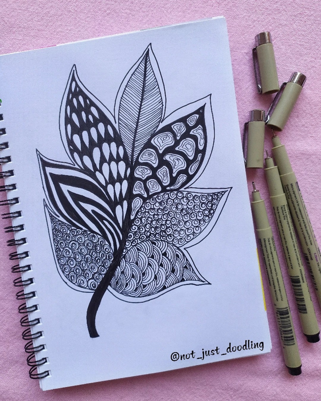 🍃🖤 Patterns Growing with Grace ✨🌱

This beautiful leafy artwork by @not_just_doodling blends bold shapes with delicate zentangle patterns, creating a piece that feels both calming and full of movement. Each section of the leaf tells its own story through texture, contrast, and flow. 🌿✨

Here are 5 creative takeaways from this artwork:

1️⃣ Organic Structure — The leaf shape brings a natural, grounding presence.
2️⃣ Pattern Variety — Each segment features a unique design, adding rhythm and curiosity.
3️⃣ Bold vs. Delicate — Thick black fills meet fine lines in a perfect visual balance.
4️⃣ Flowing Motion — Repeated curves and waves guide the eye smoothly across the piece.
5️⃣ Mindful Detailing — A reminder of how calming and meditative slow, intentional strokes can be. 💛

Art by: @not_just_doodling 🎨✨

#ZentangleArt #PatternDesign #LeafArt #MindfulDrawing #CreativeCalm #DoodleArtClub #InspiringArtists #SketchbookMagic #ArtForRelaxation #CreativeFlow