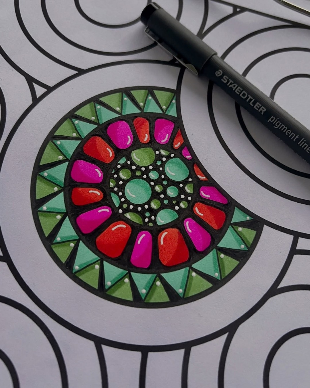 This eye-catching artwork by @ginakrupsky turns a simple circular design into a vibrant geometric flower. The bold pink, red, and green shapes stand out beautifully against the strong black outlines, while the detailed center adds depth and character. 🎨

The bright colors, repeating patterns, and glossy white highlights create a playful yet beautifully balanced design that is full of energy and creativity. ✨

Why this artwork stands out:

1️⃣ Bold color combination — vivid pinks, reds, and greens create an energetic visual impact
2️⃣ Geometric floral design — repeated petal and circular forms create a beautifully organized composition
3️⃣ Strong linework — thick black outlines make each colorful section stand out clearly
4️⃣ Detailed center — layered circles, dots, and small shapes add depth and visual interest
5️⃣ Glossy highlights — carefully placed white accents give the colored elements a polished, dimensional look

Art by: @ginakrupsky 🤍

#DoodleArt #PatternArt #ColorfulArt #MandalaArt #GeometricArt #DoodleArtClub #HandDrawnArt #MarkerArt #CreativePatterns #AbstractArt #ArtInspiration #MindfulArt #DecorativeArt #SketchbookArt #ArtCommunity